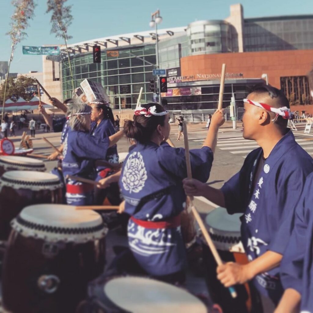 Photo of Bombu Taiko group performing across the street from JANM